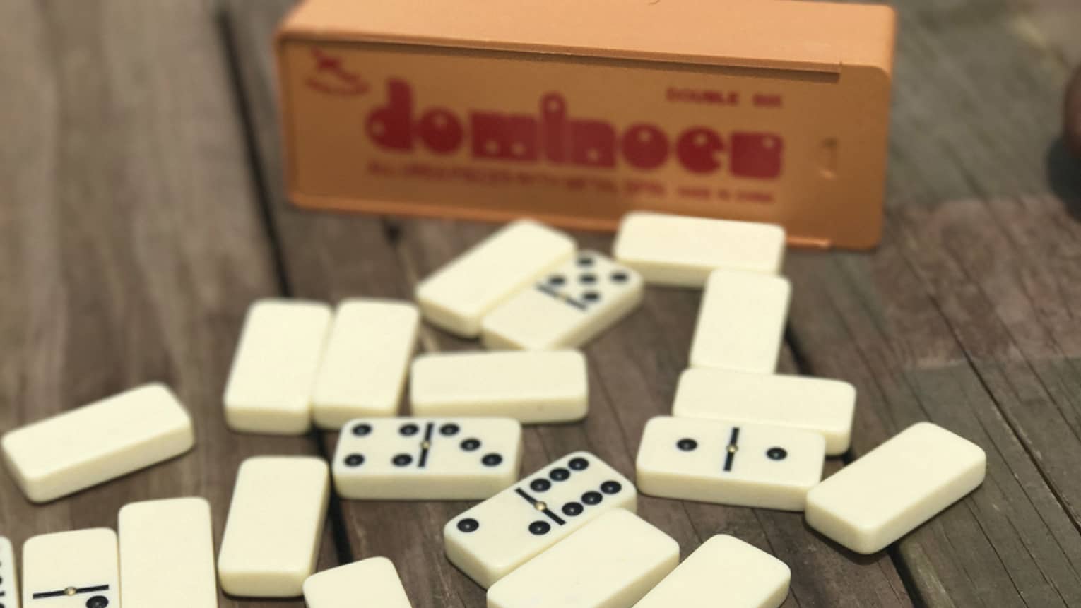 Dominoes on table, box in background