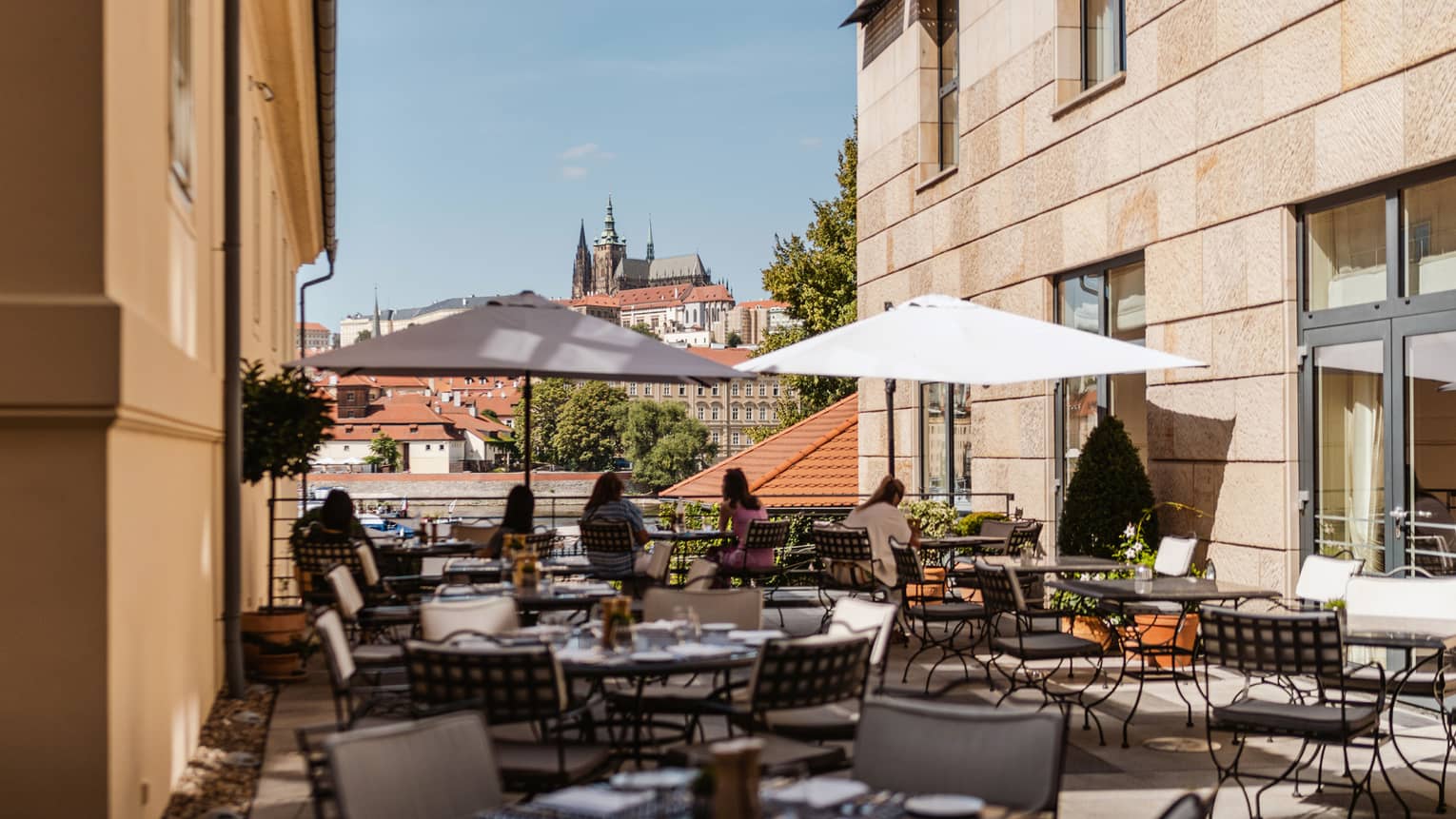 Rooftop terrace with wrought iron tables and market umbrellas