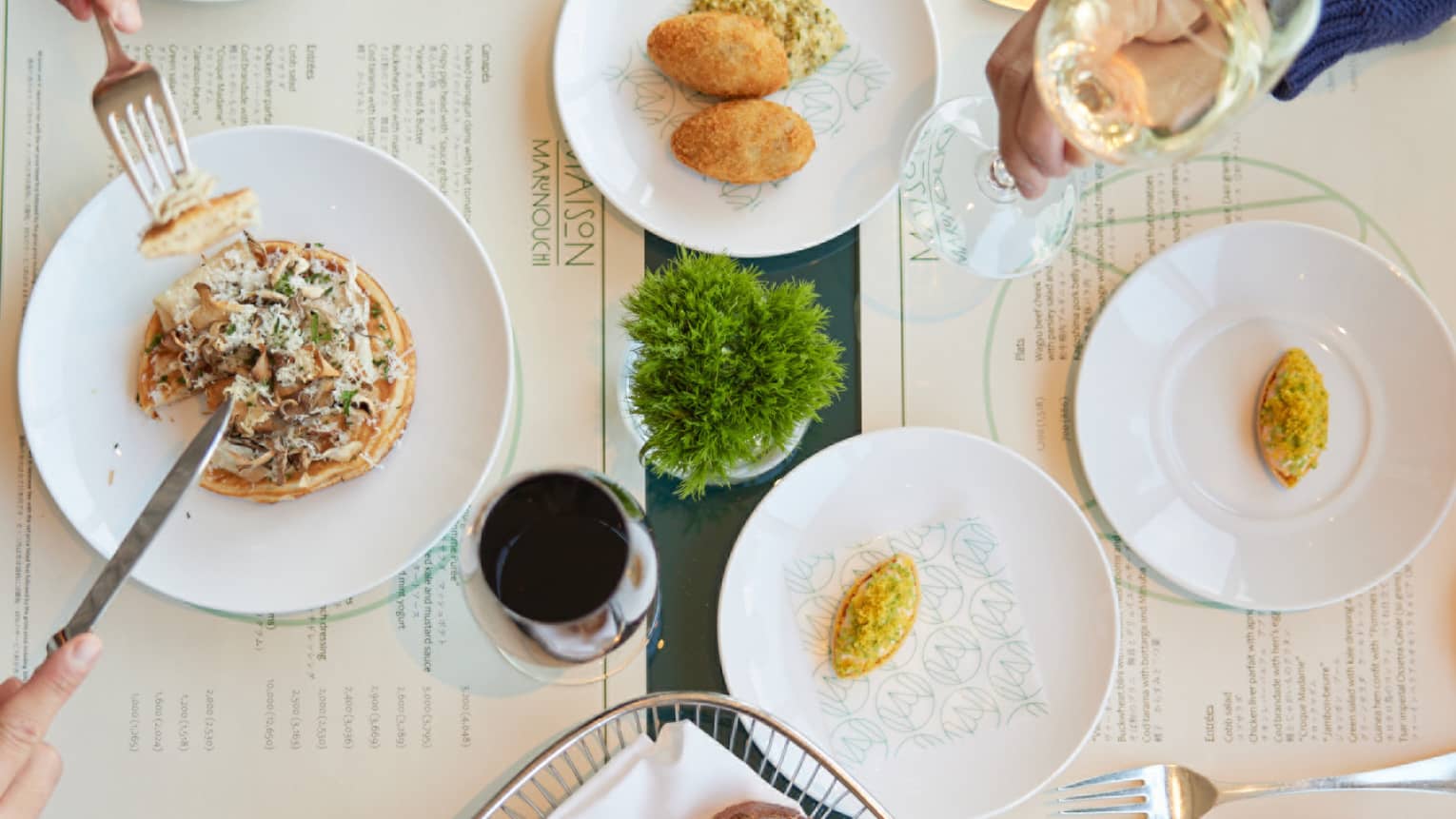 Table for two, with plates of bread and fritters