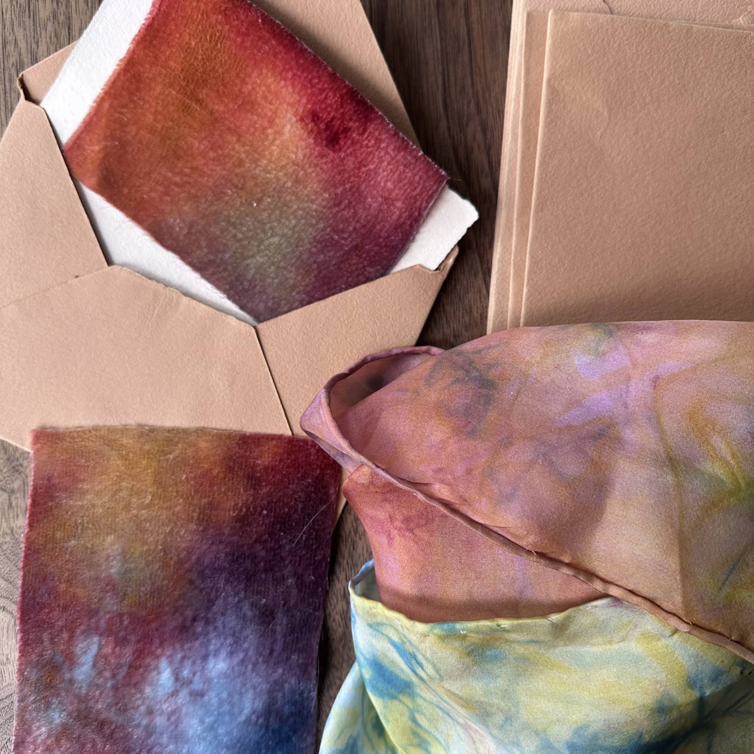Scarves dyed with various colours and placed in envelopes