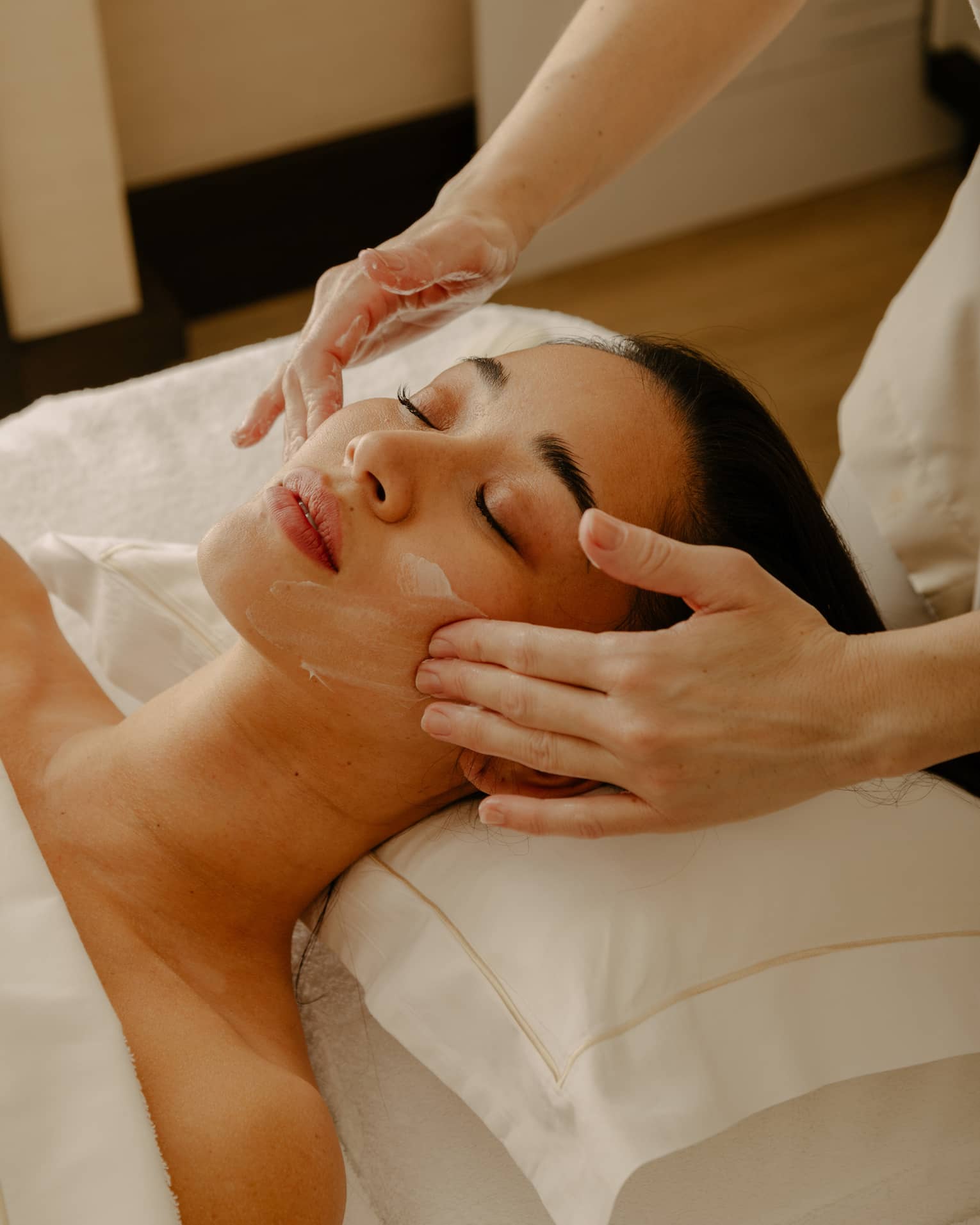 Close up of woman's face getting a facial