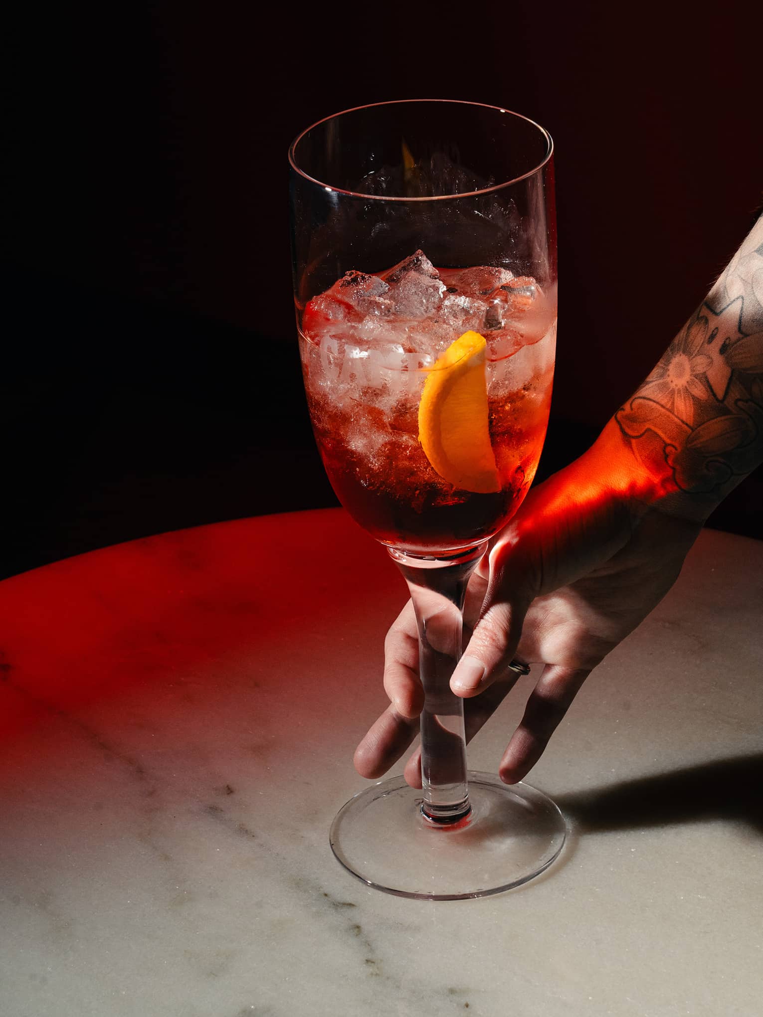 Sbagliato cocktail garnished with an orange slice
