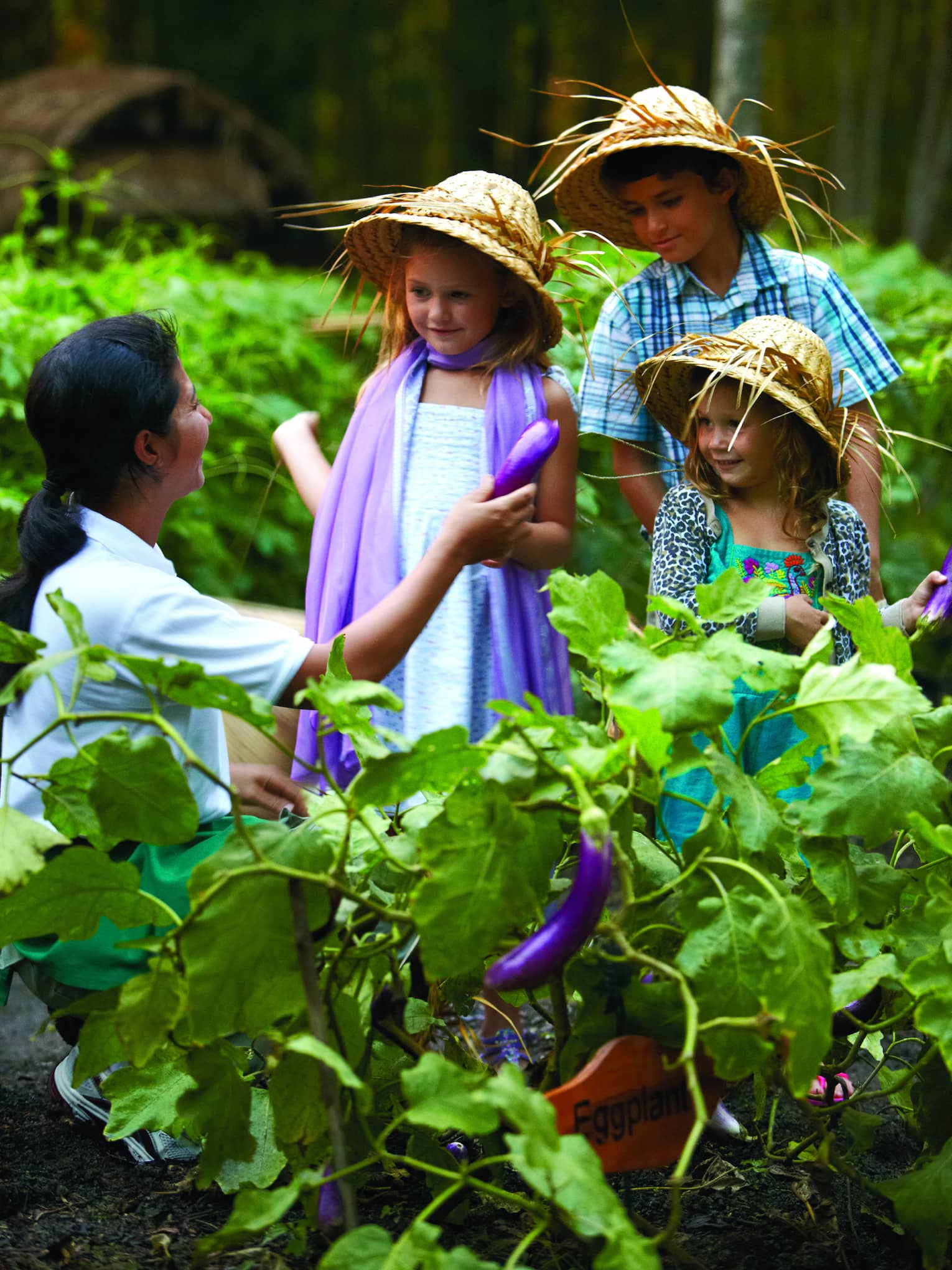 Three children learning about food and culture in a chef-guided class outdoors