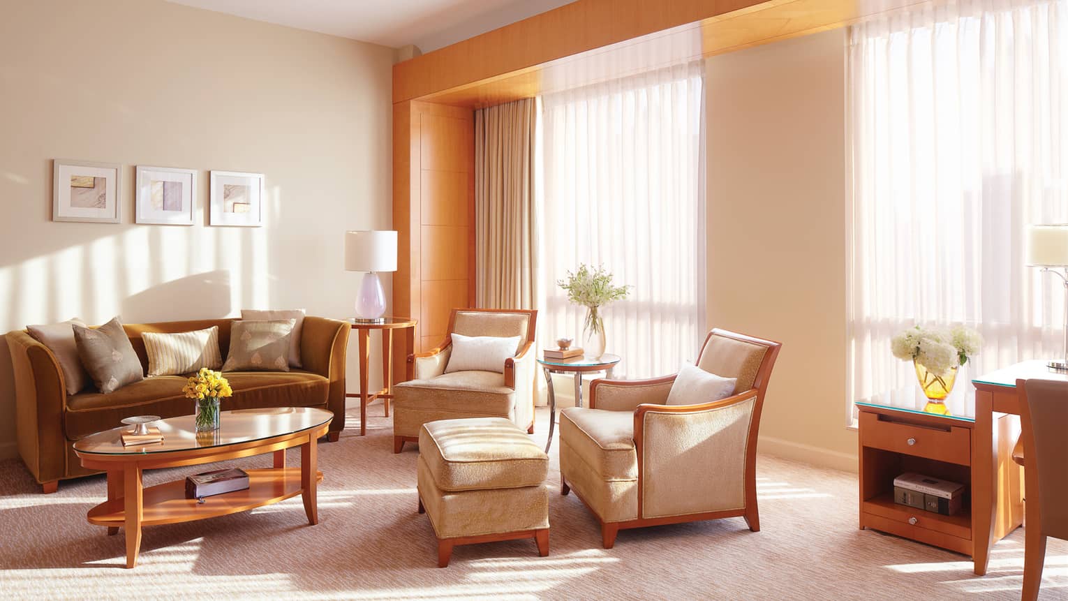 Executive Suite beige velvet armchairs, bronze sofa, table by large windows, sheer curtains
