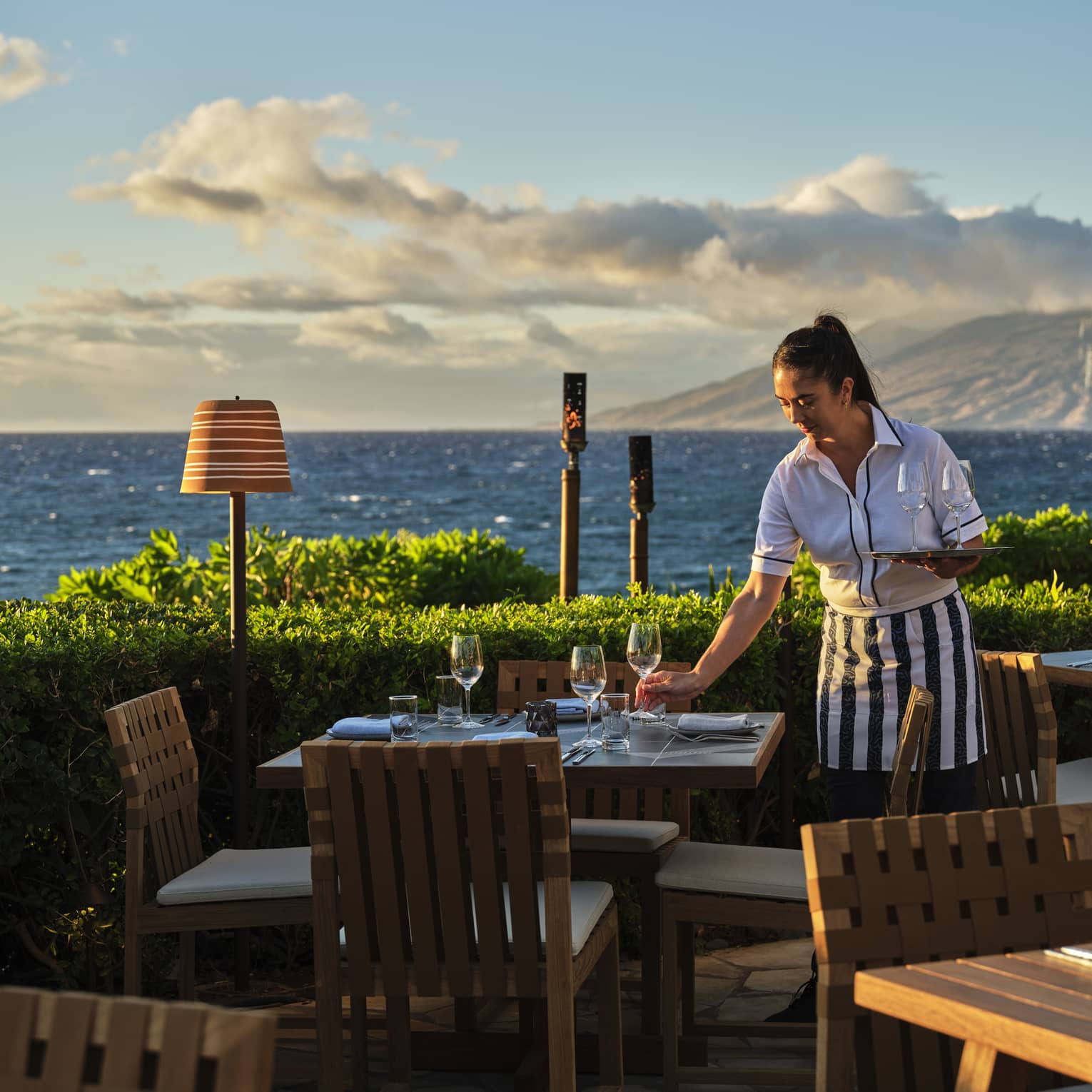 Server sets table at oceanside Ferraro's Restaurant