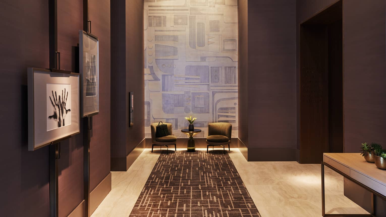 dark purple corridor with featured artwork on the walls