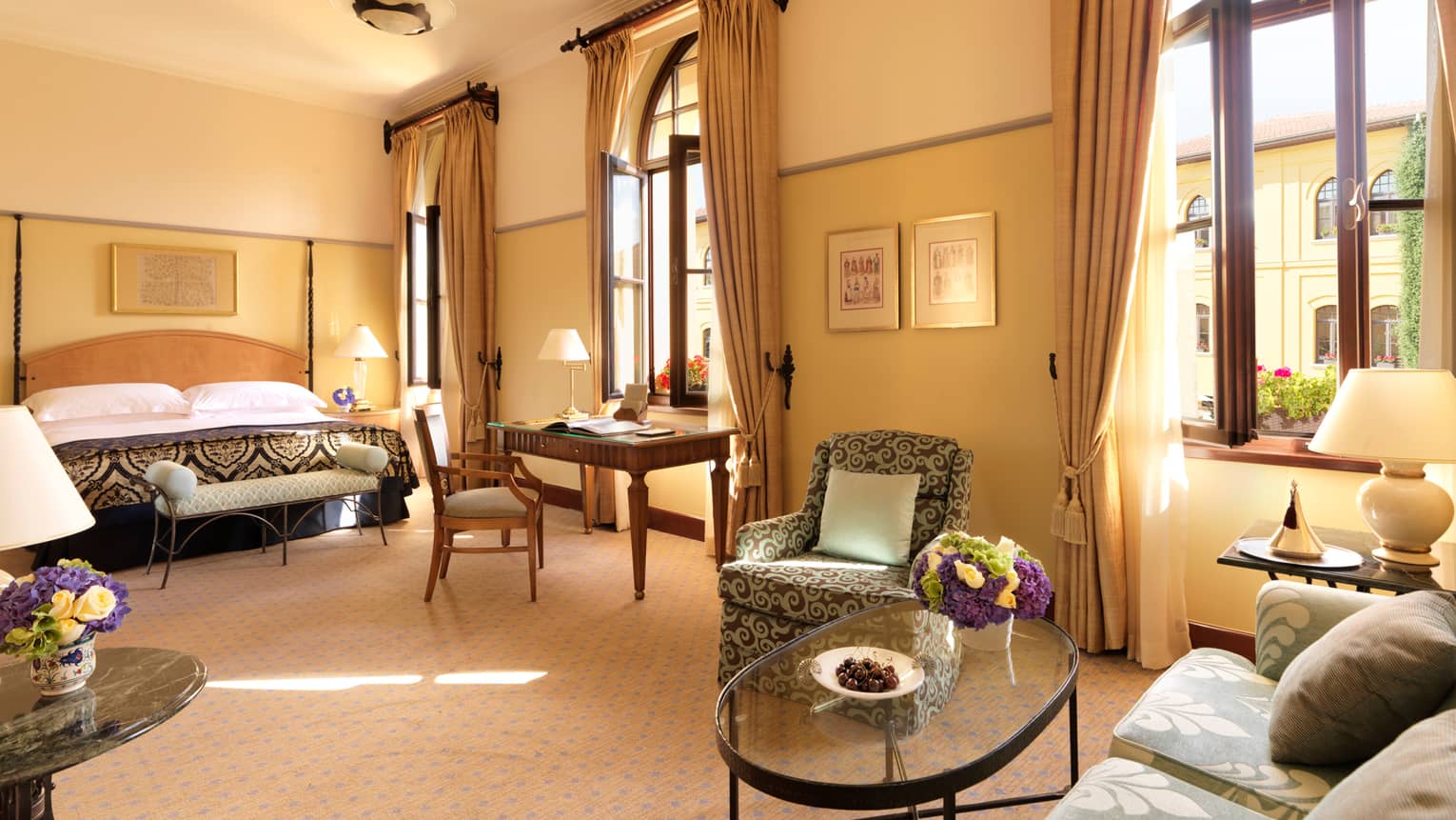 Premier Room seating area, glass coffee table, bed, tall windows