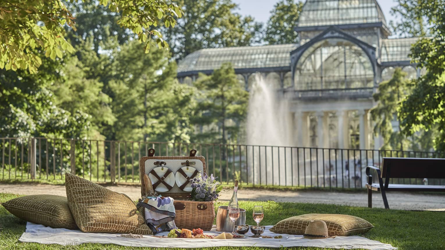 Picnic setup near water fountain and park bench at Parque del Retire