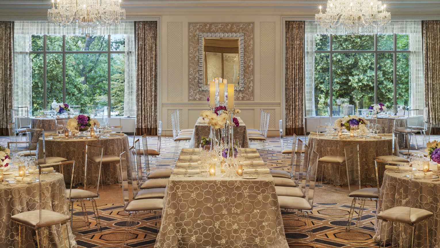 Ballroom Social setup with tables, chairs under two large windows, crystal chandeliers 