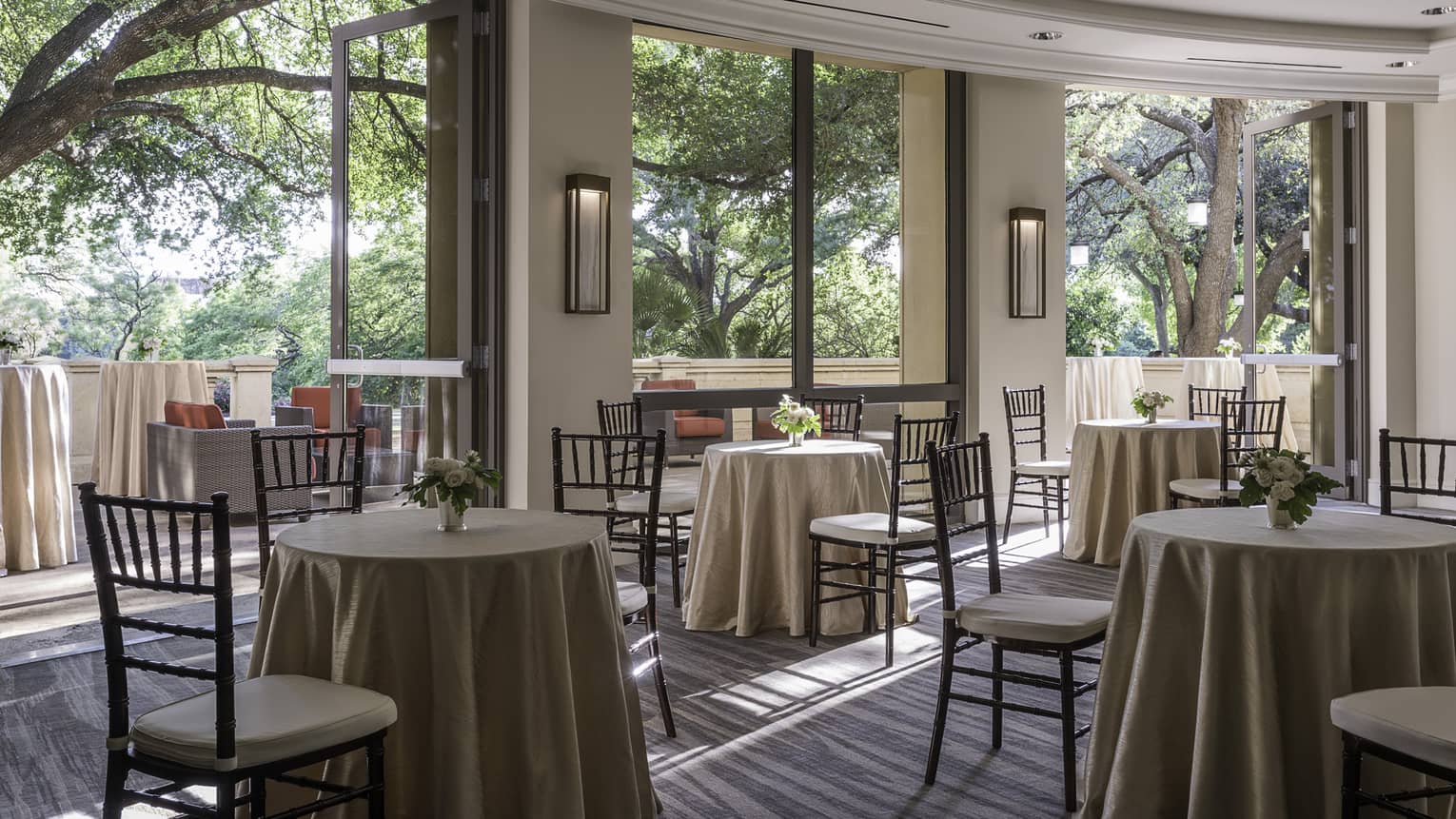 San Jacinto Pre-function room with small tables and chairs by open walls to sunny patio