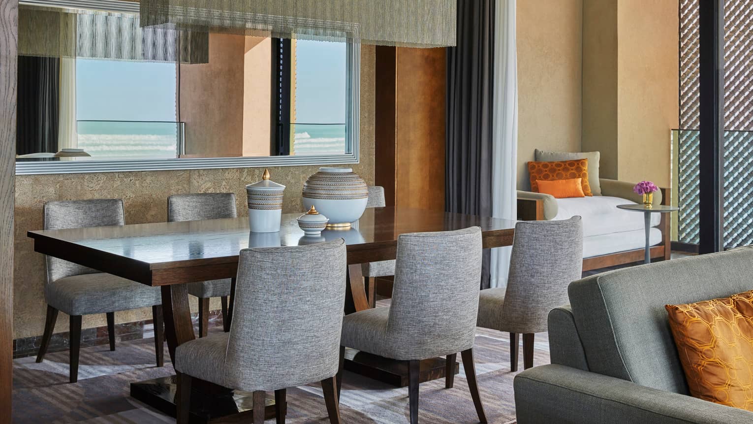 Signature Suite dining room table with grey chairs, white-and-gold ceramics