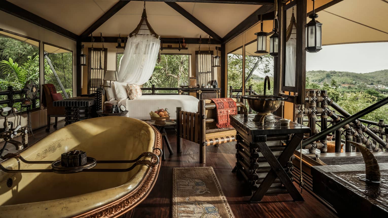 Superior Tent with bed, sheer white net, freestanding tub, wood furniture, lanterns