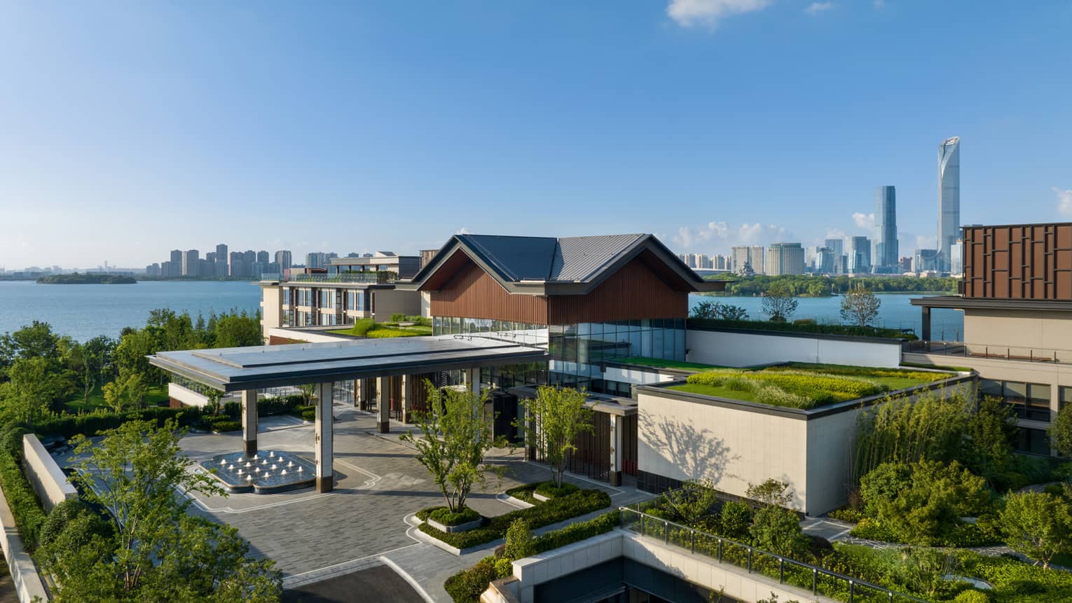 Exterior of Four Seasons Hotel Suzhou, with lake and city in background