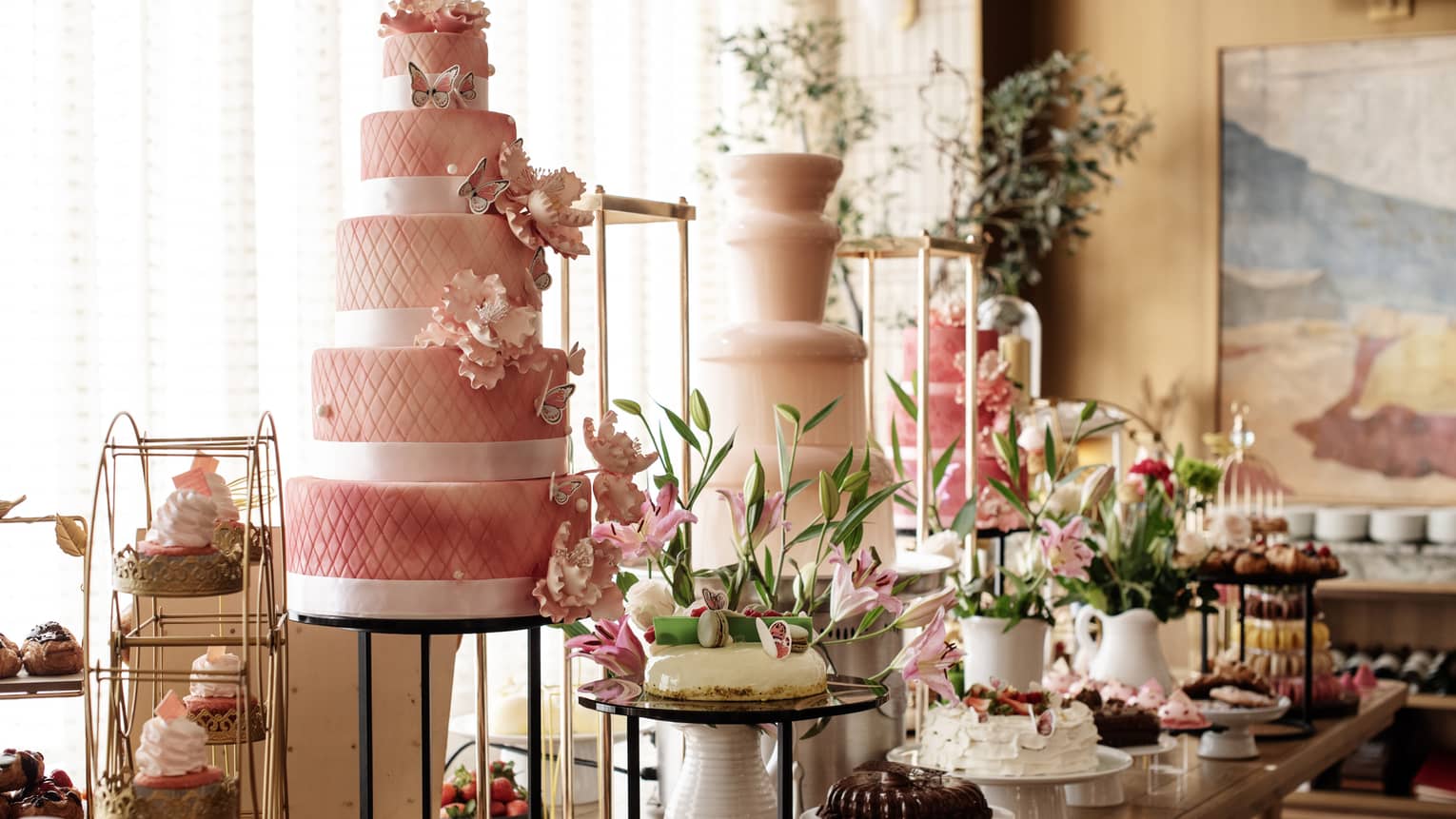 A buffet with cakes, cupcakes and desserts