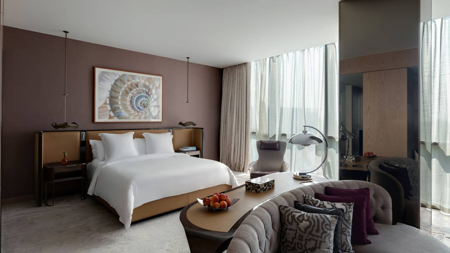 Bedroom with brown wall, windows, king bed and sitting area