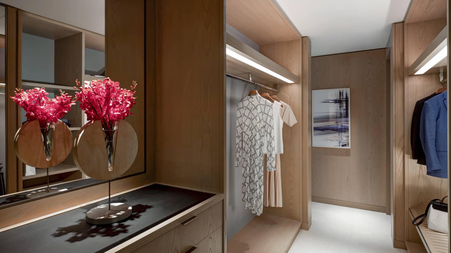 Illuminated walk-in closet with wooden built-ins