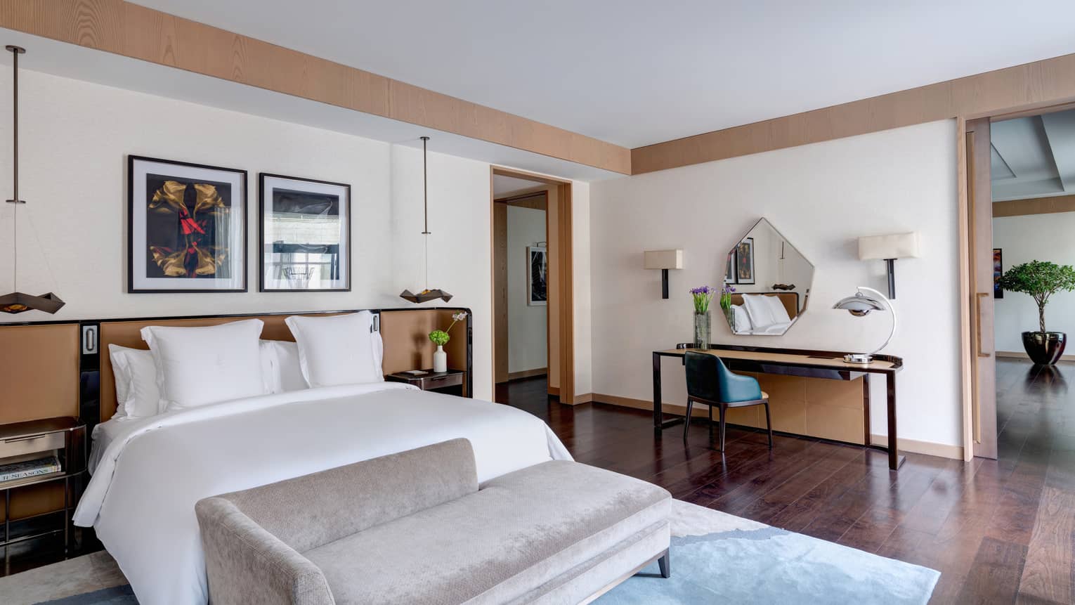 Bedroom with king bed, grey chaise and desk