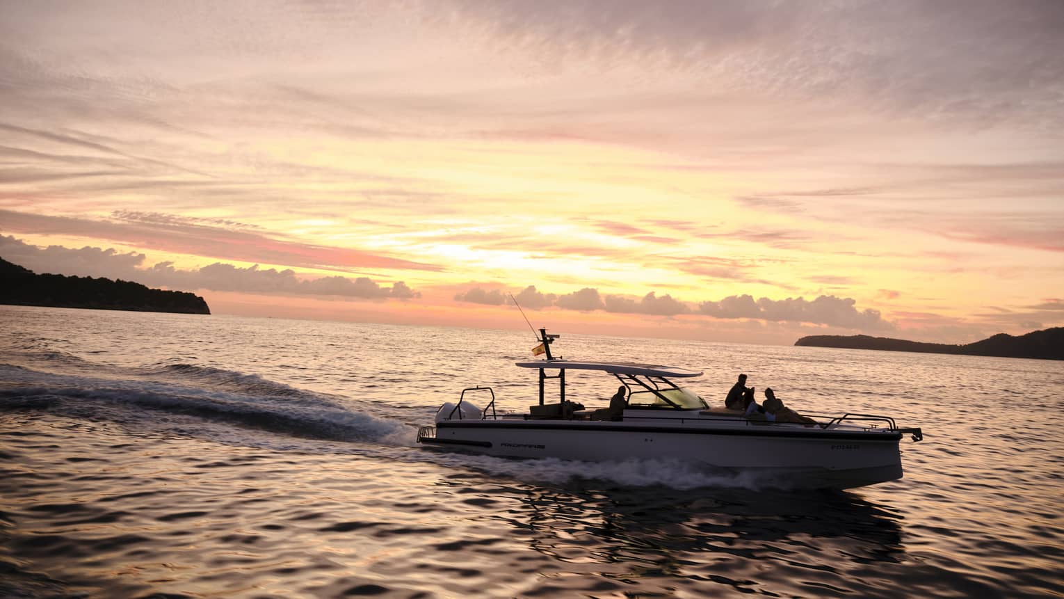 A boat on the water at sunset in island destination