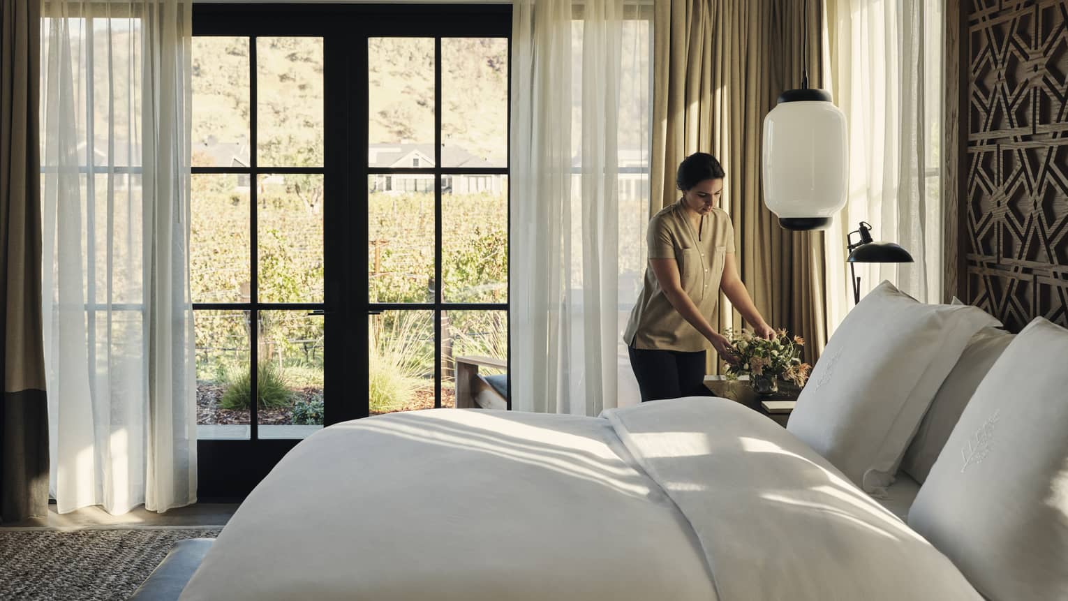 A hotel team member organizing a room.