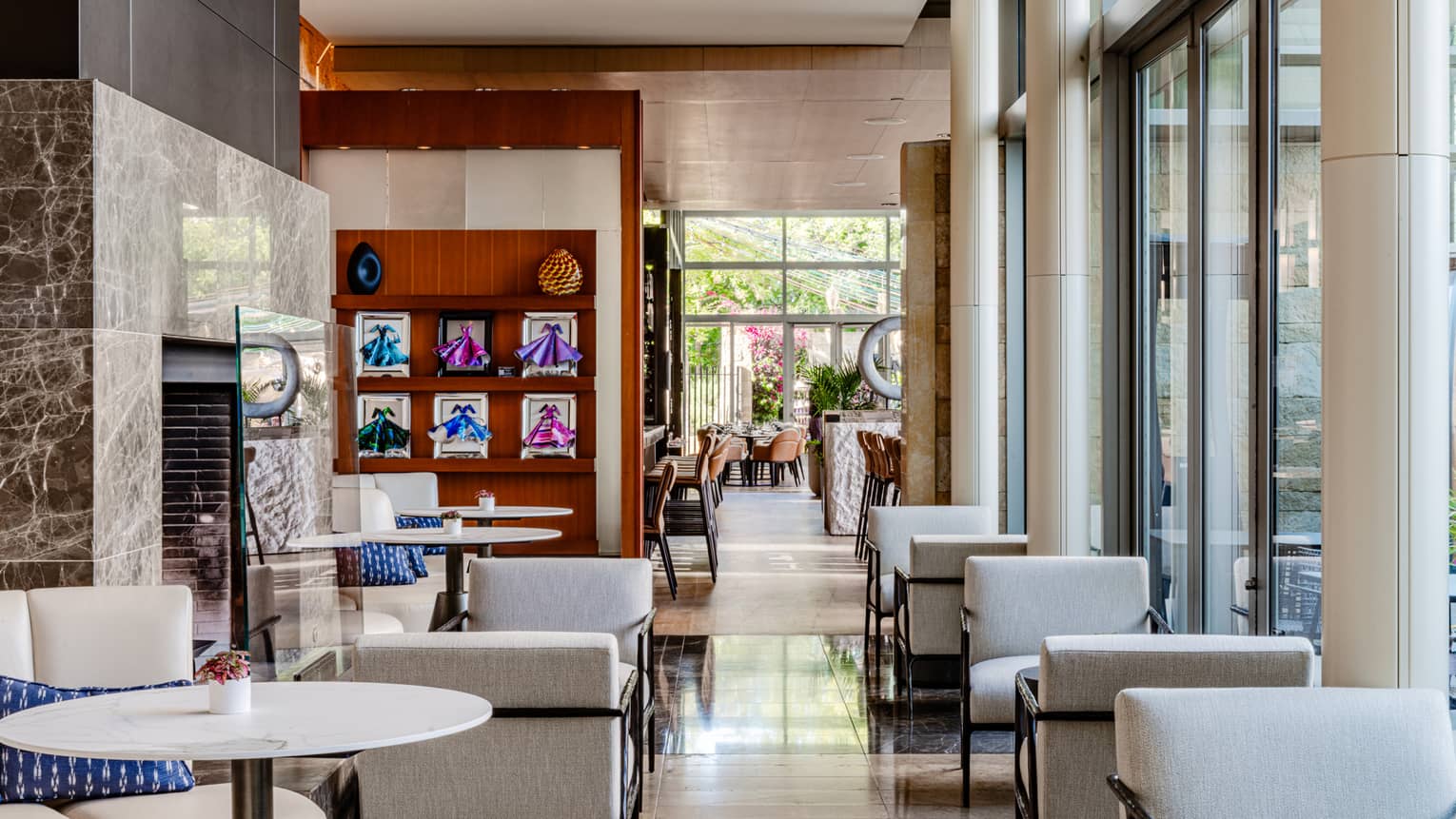 A restaurant with a fireplace and floor to ceiling windows