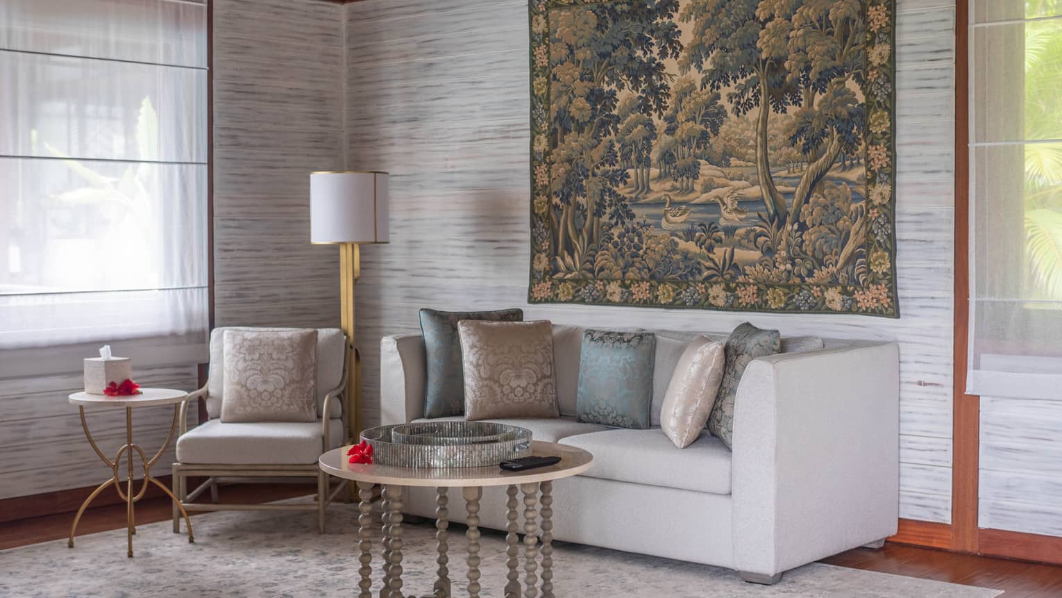 Living room with two-seat grey sofa and arm chair