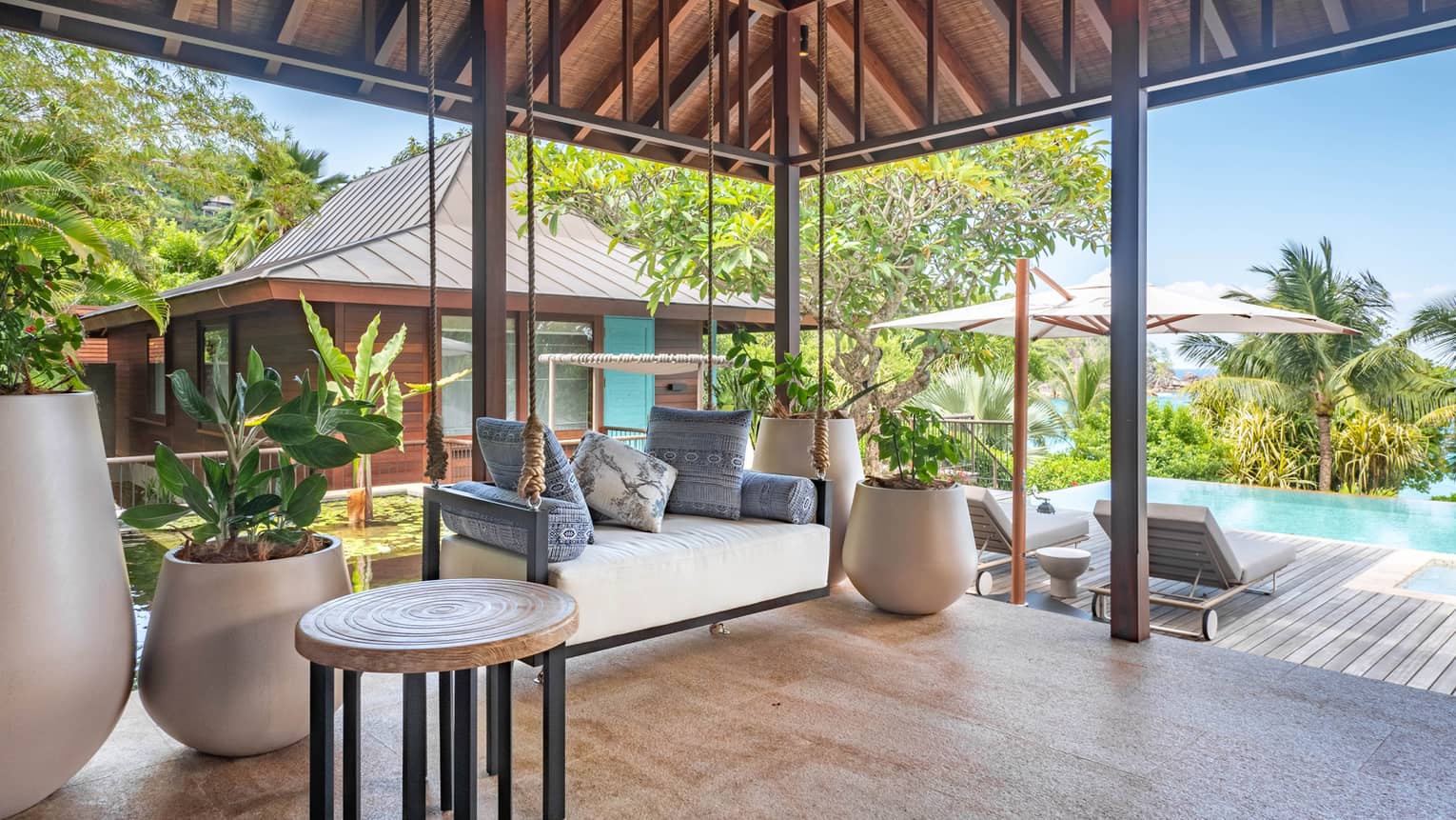 Covered outdoor patio and adjacent pool terrace