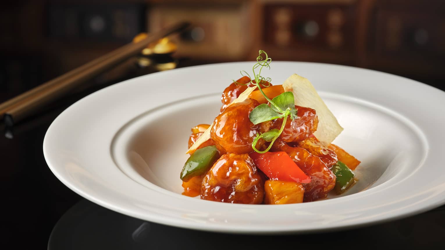 Sweet and sour dish with vegetables served in white bowl 