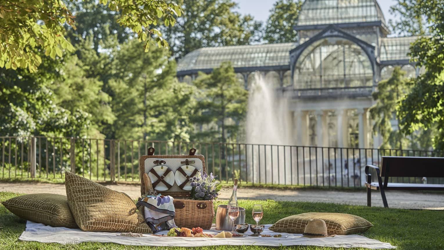 Picnic setup near water fountain and park bench at Parque del Retire