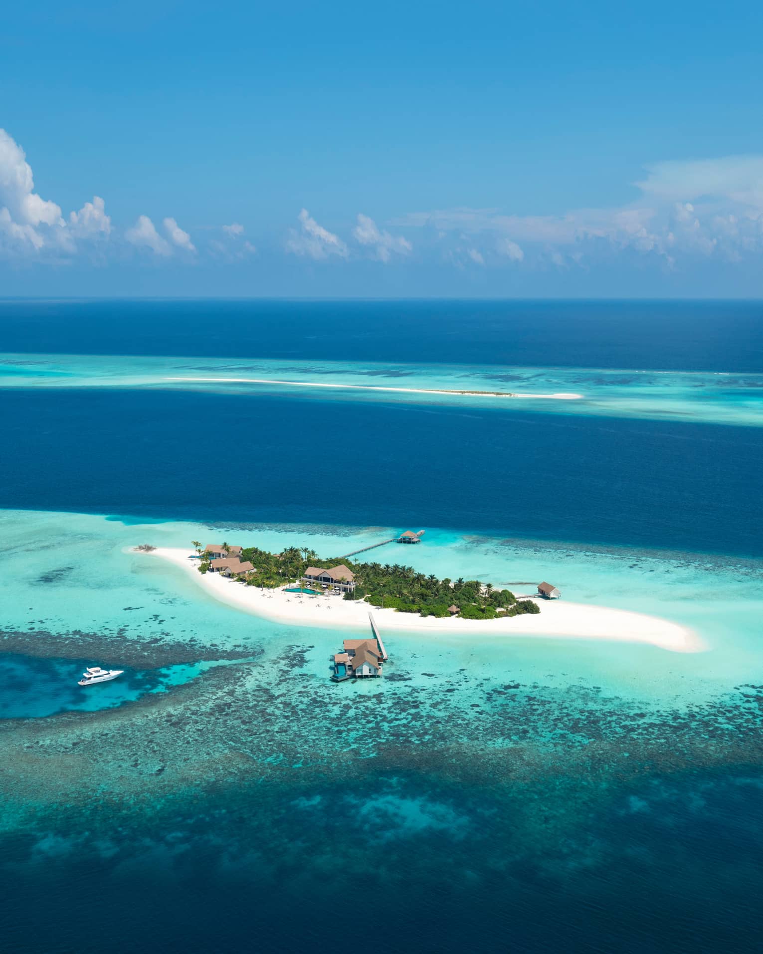 Aerial view of Maldives Private Island at Voavah, Baa Atoll with private sand beach, lagoon