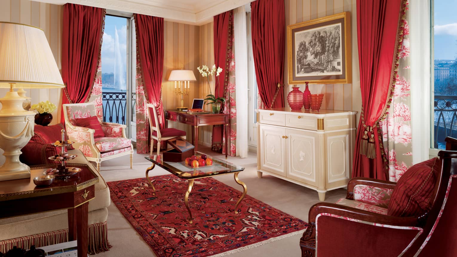 Suite Mont Blanc with dark red curtains, accent chair and rug, glass coffee table, French balcony at dusk