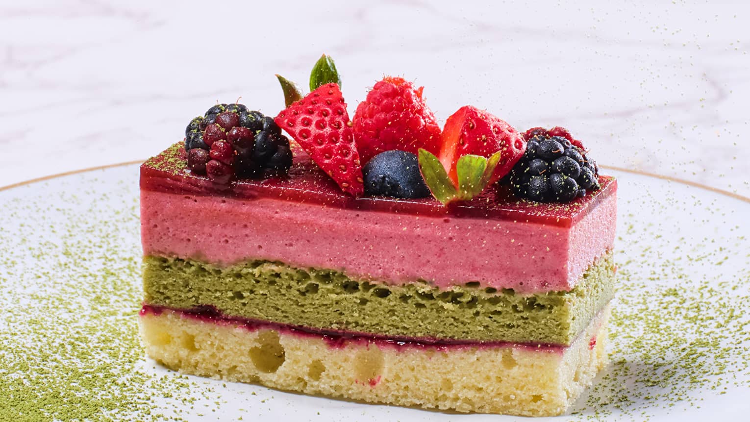 Lemon berry matcha cake with raspberry, strawberry and blueberry slices