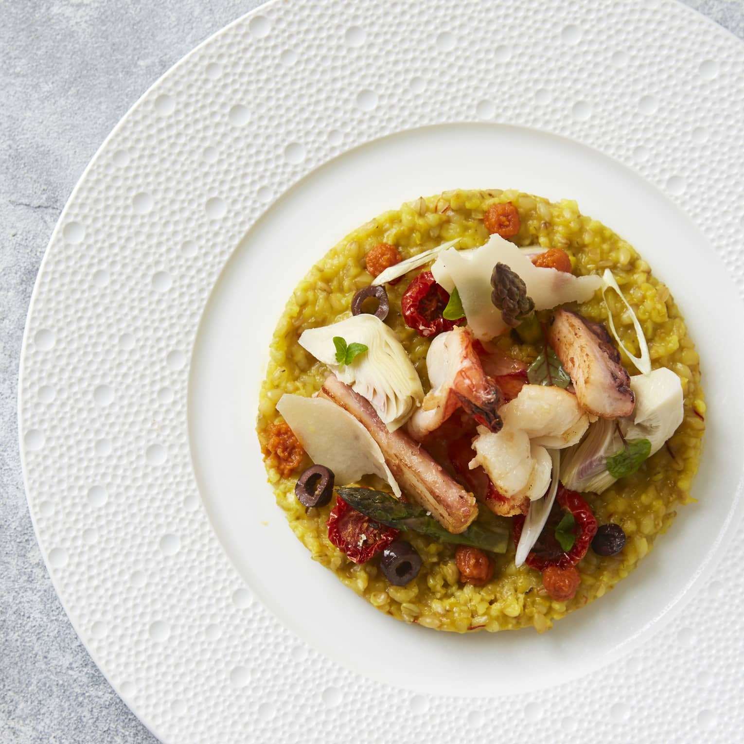 A seafood risotto dish served on a white plate