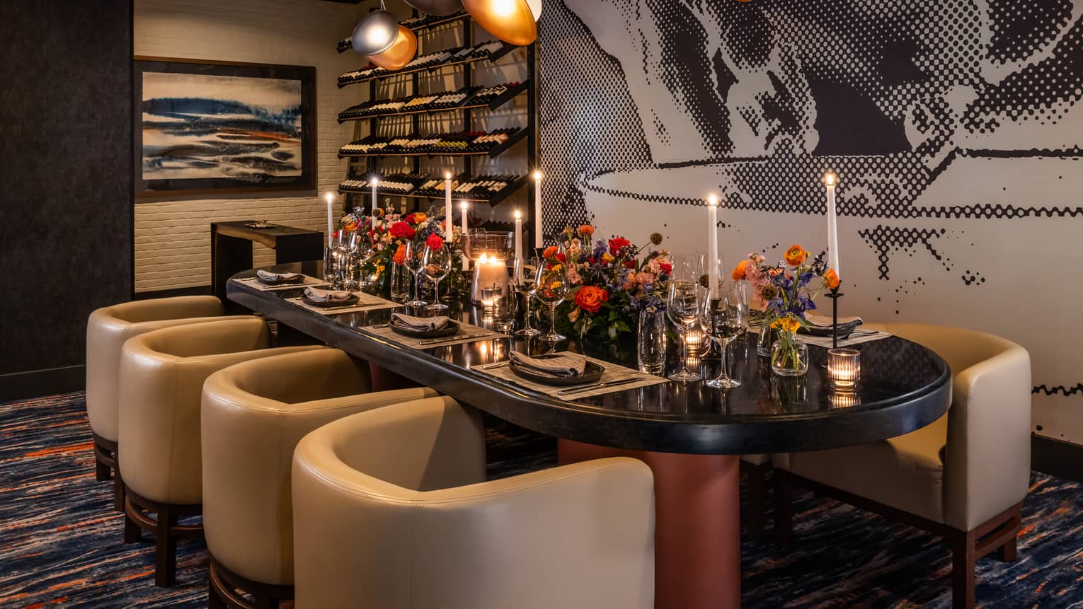 Dining table set with flower vases and candles with lights above and wall art