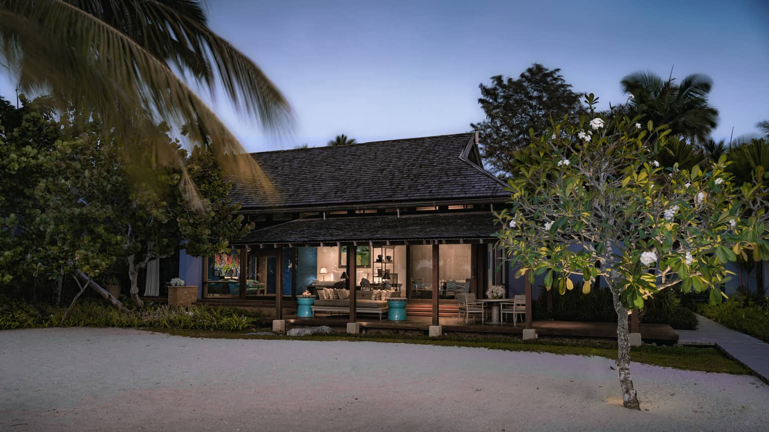 Deluxe Family Beach exterior at night with lights from sandy beach