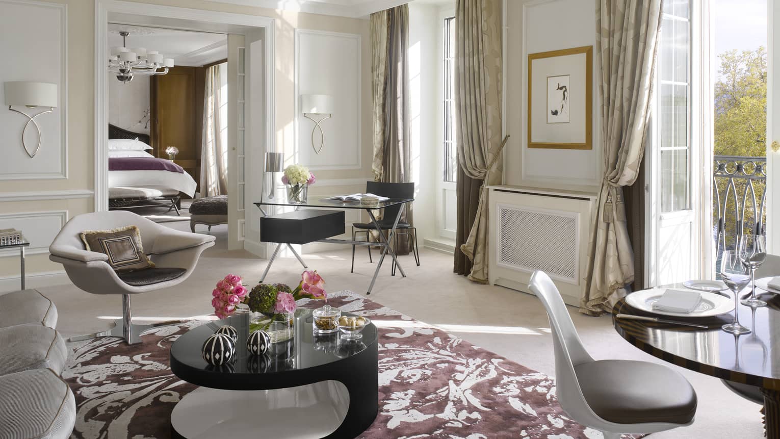 Presidential Suite bright living area with retro-style armchair, dining table by French doors to balcony with Lake Léman views