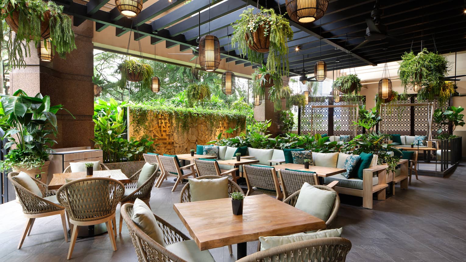 Garden@One-Ninety outdoor lounge with rattan chairs, square tables for four, portico ceiling, hanging plants and lighting