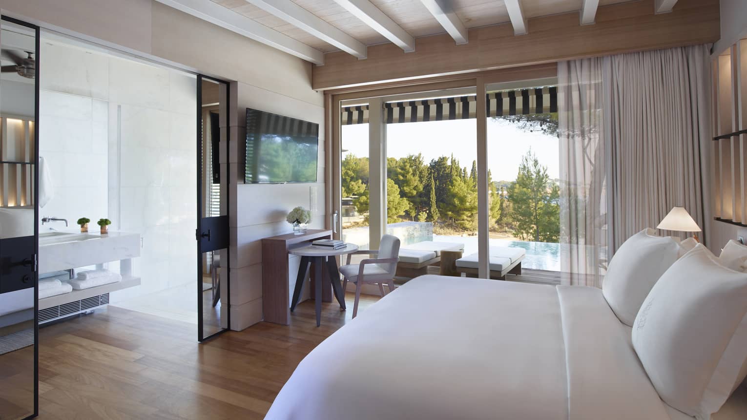 Bungalow  Sea View with Pool, white King bed, mirrored doors to bathroom, floor-to-ceiling window overlooking pool, desk and chair