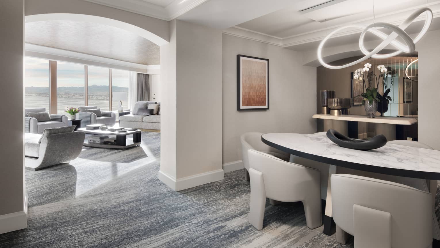 Modern dining room of luxury suite at Four Seasons Hotel Las Vegas, with marble oval table and large leather chairs