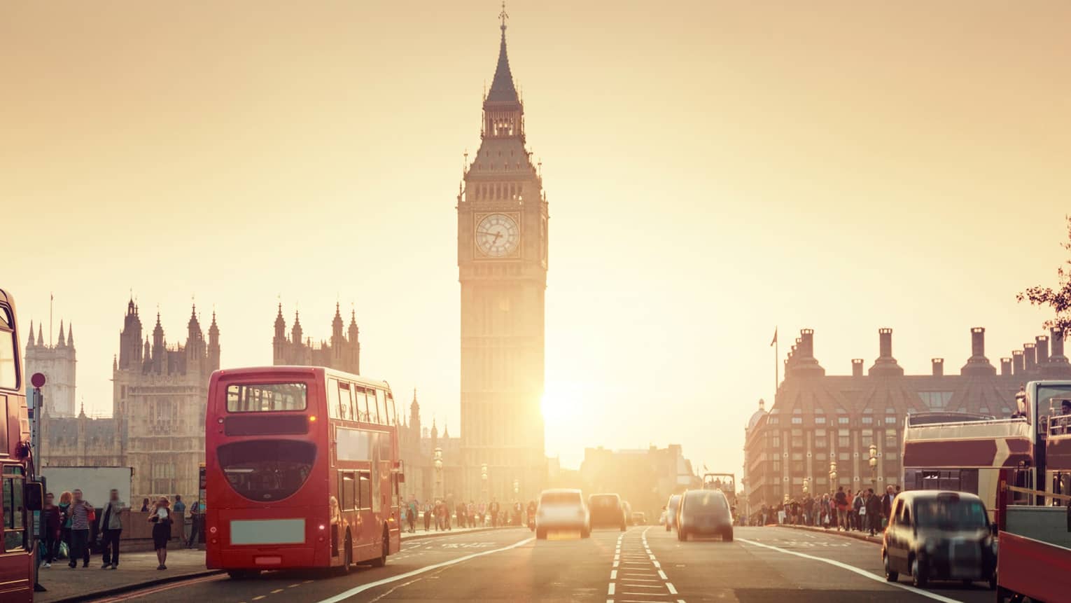 Street view of London at sunset, Big Ben tower and red double-decker bus in background