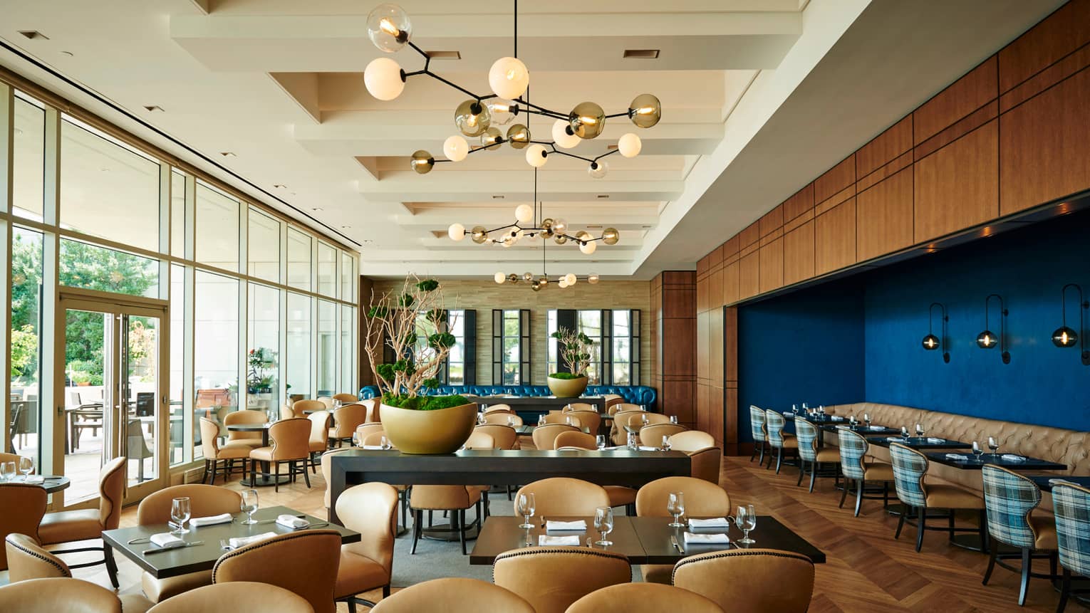 Cinder House dining room with modern decor, floor-to-ceiling windows