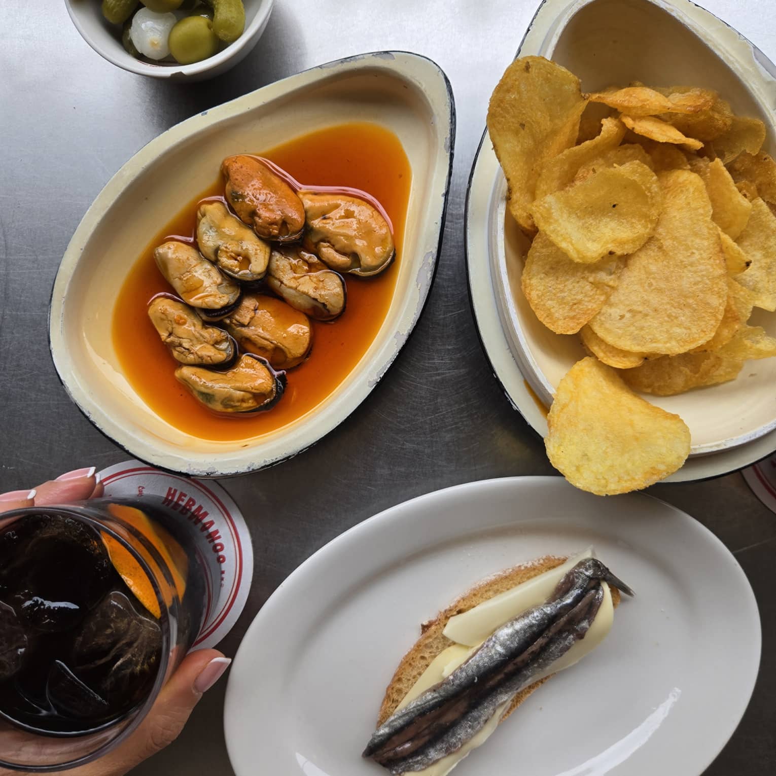 Seafood dish with chips on the side and a drinking glass