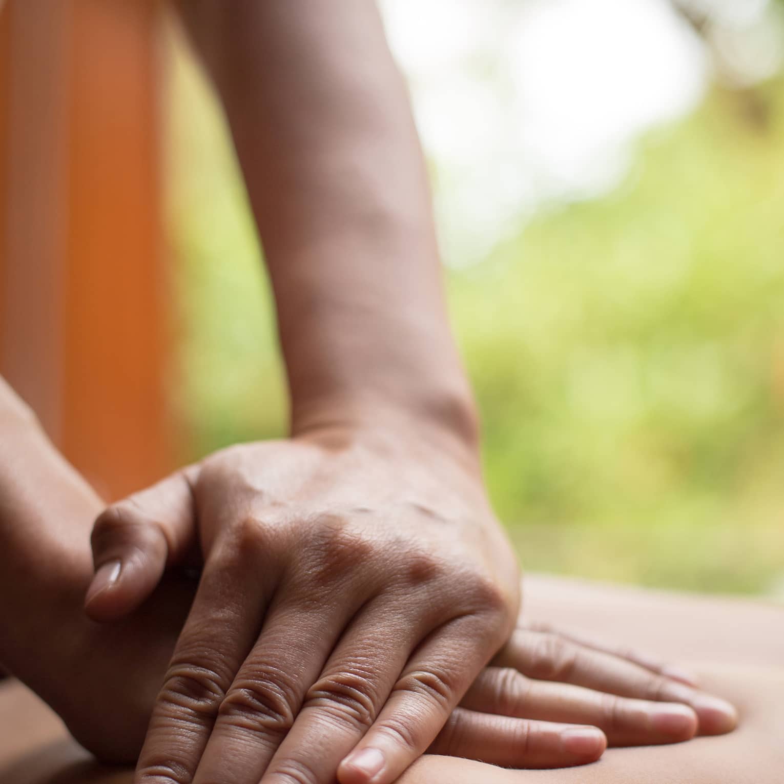 Close up of hands massaging a back