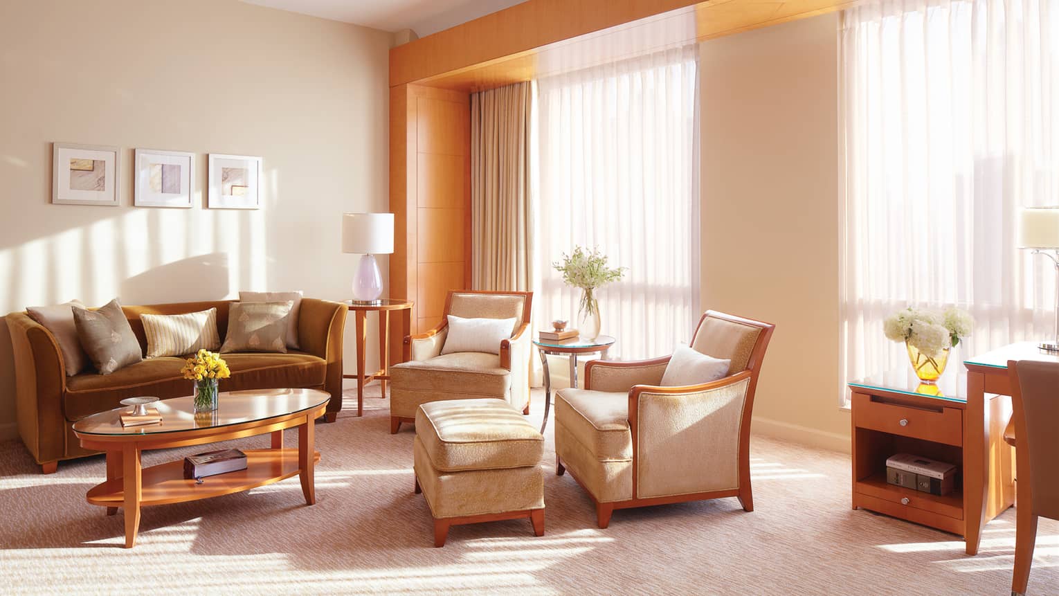 Executive Suite beige velvet armchairs, bronze sofa, table by large windows, sheer curtains