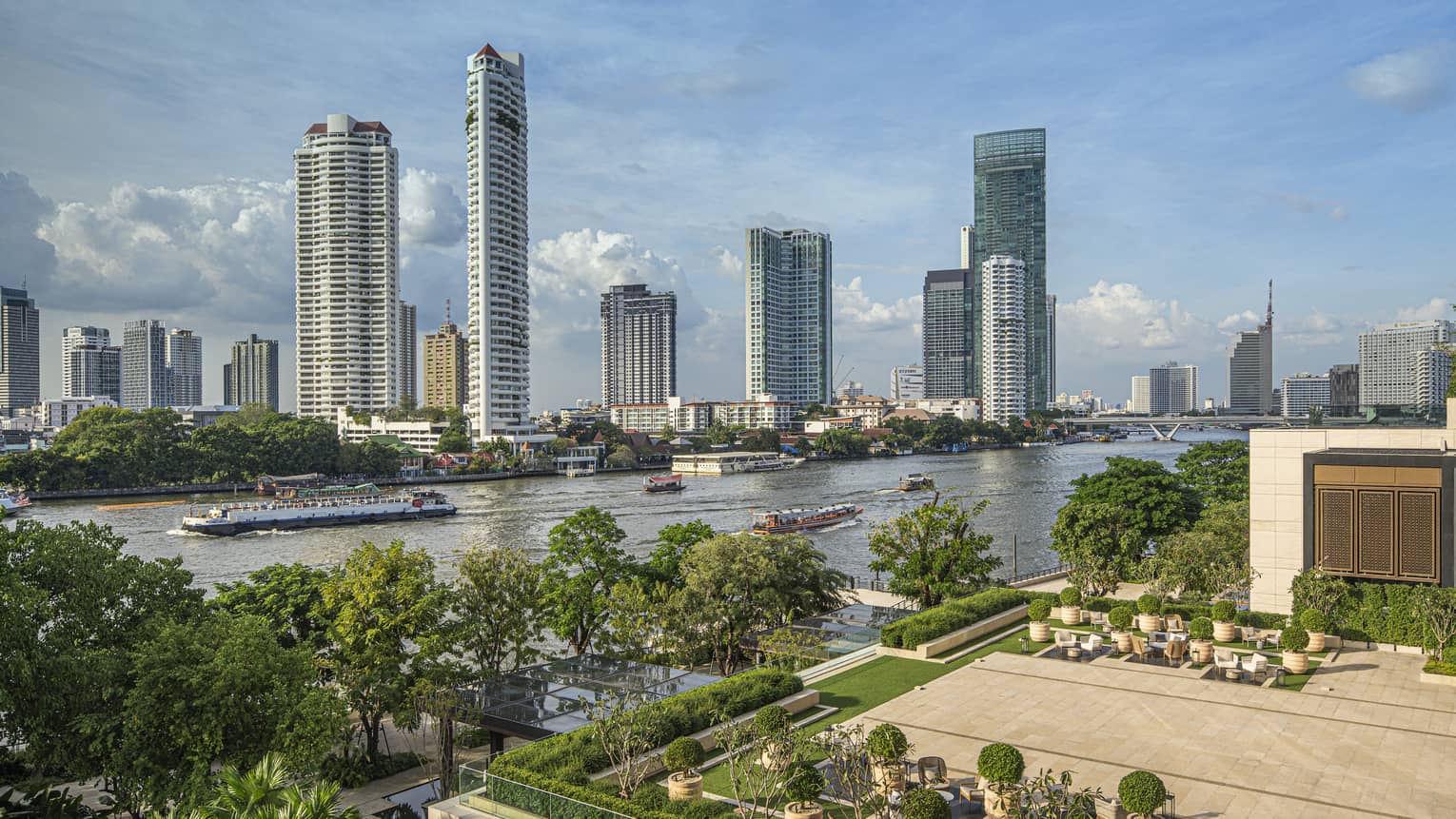 Outdoor terrace with landscaping around edge, view of Chao Phraya River in Bangkok