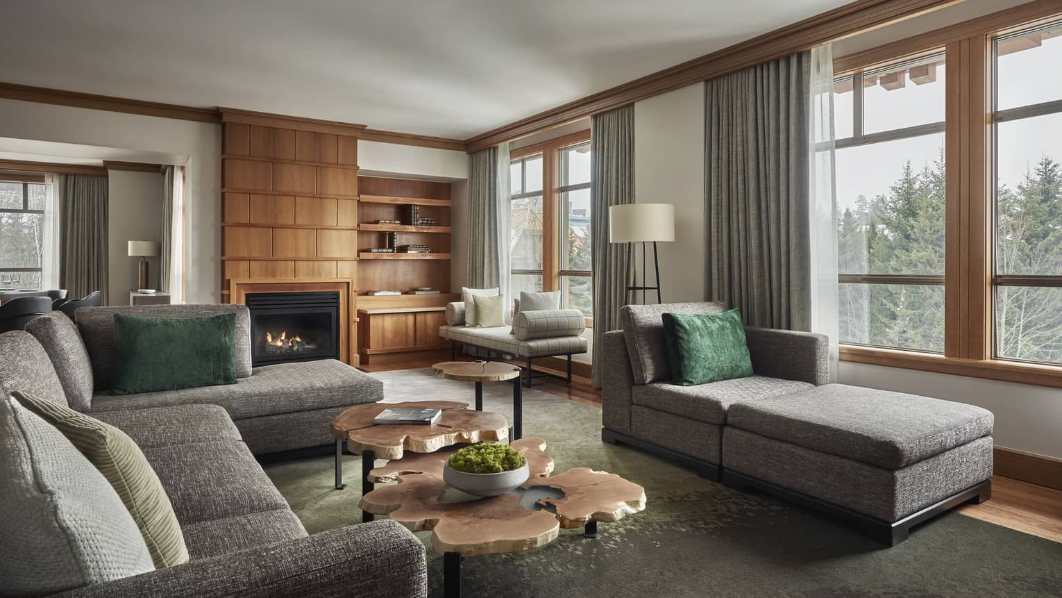 Living room of a Panorama Suite, with a large grey sofa and matching chaise lounge