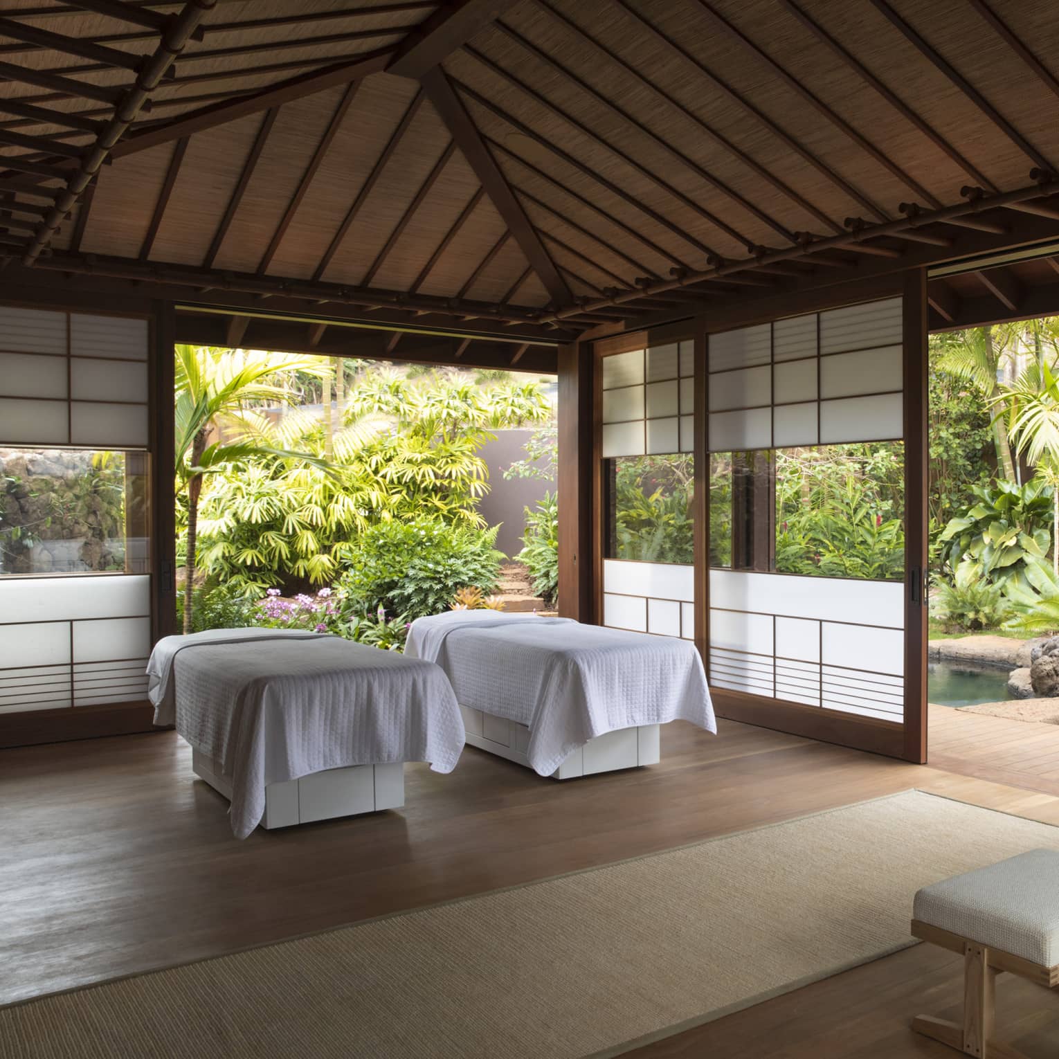 An airy indoor spa surrounded by lush flora