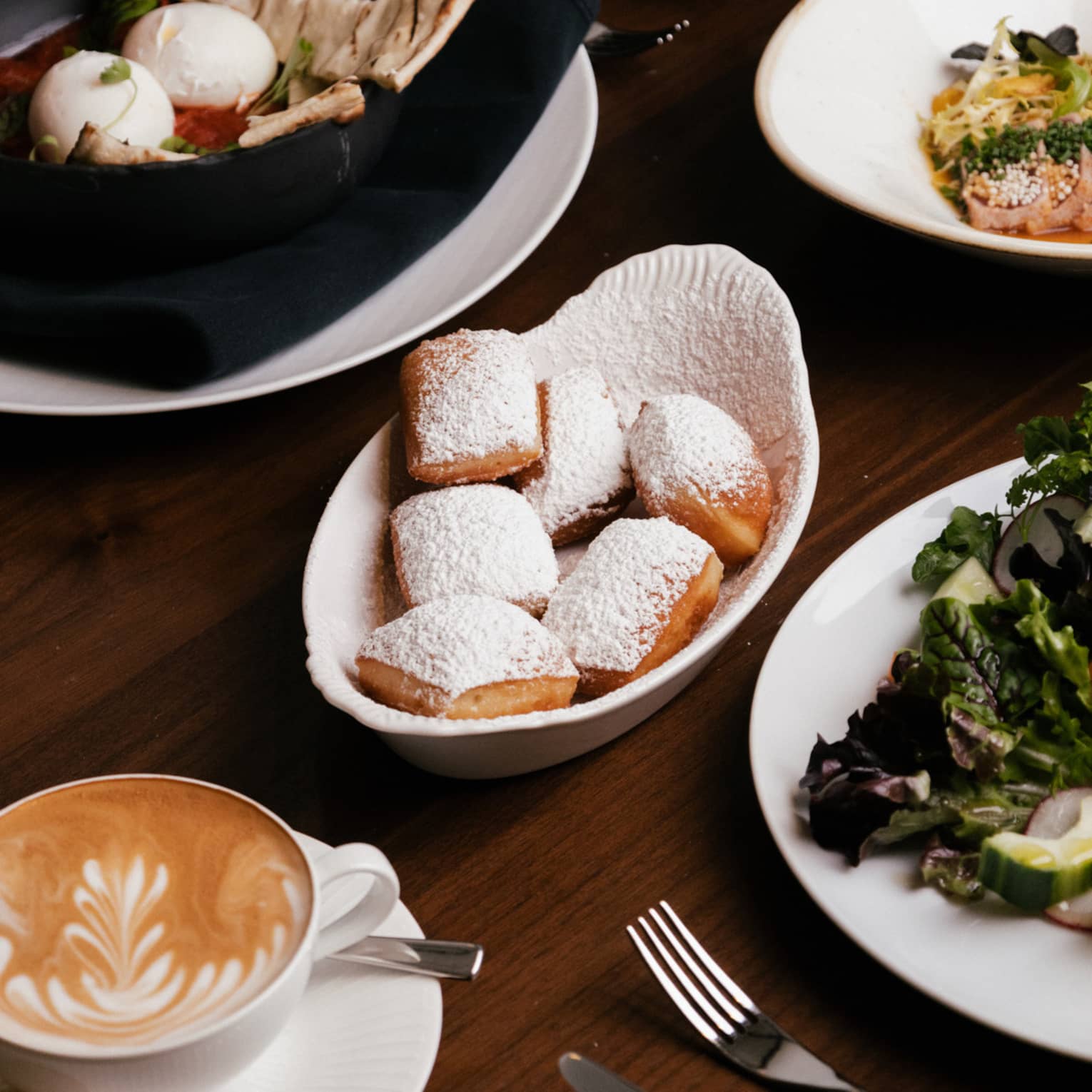 An assortment of brunch dishes arrayed on a wood table
