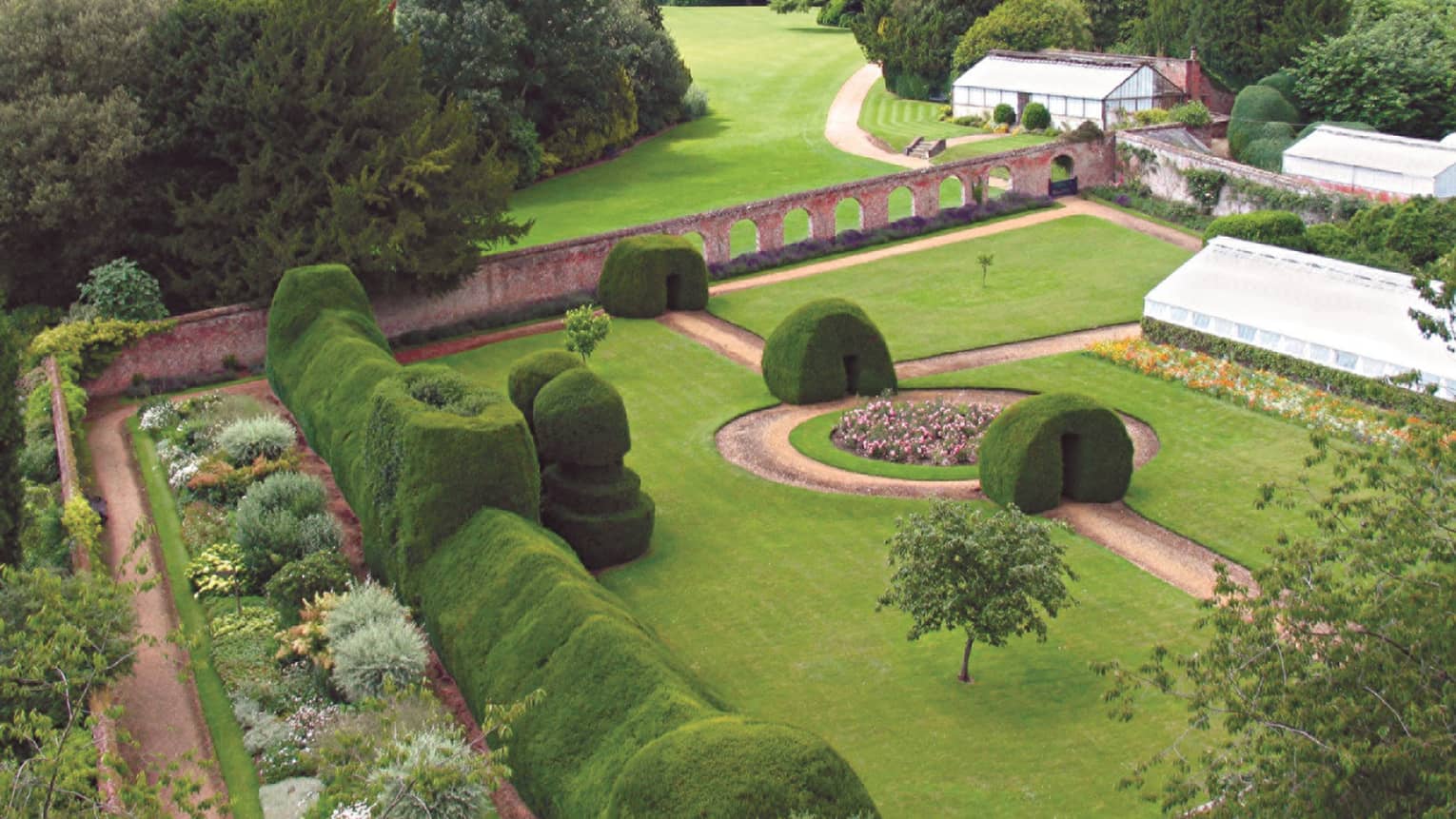 Aerial view over sprawling green gardens and Four Seasons Hotel Hampshire hotel exterior