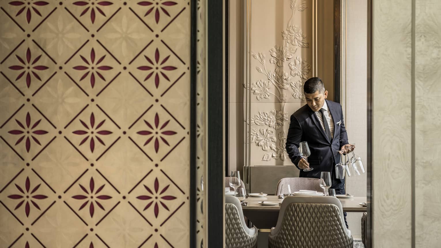 Curate private dining room with server setting the table