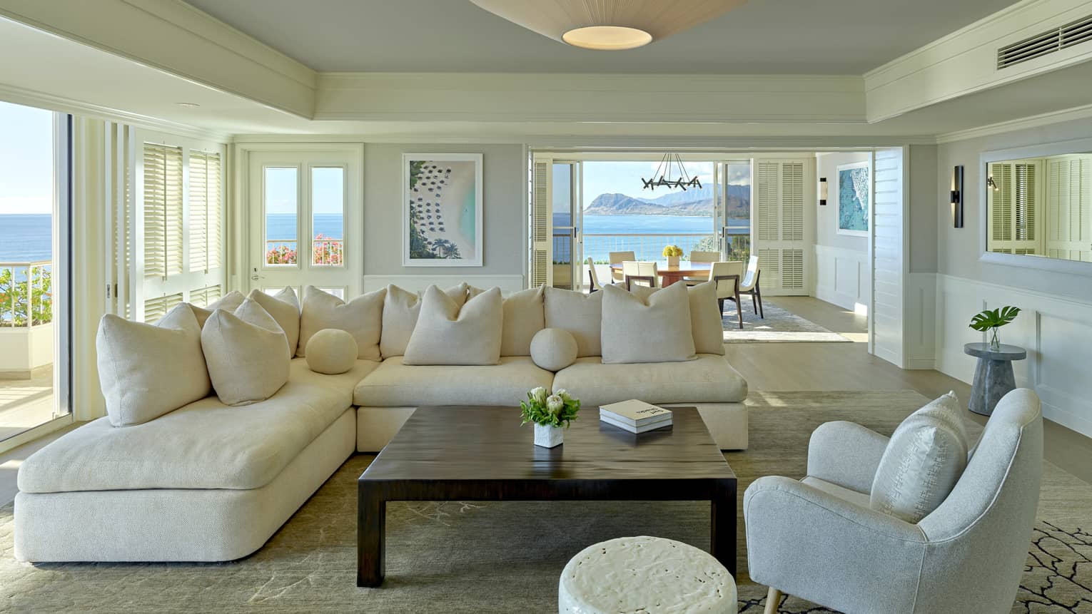 Living room with cream sectional sofa, grey arm chair, square table